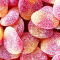 Gesuikerde perziken in roze en oranje met suikerlaag