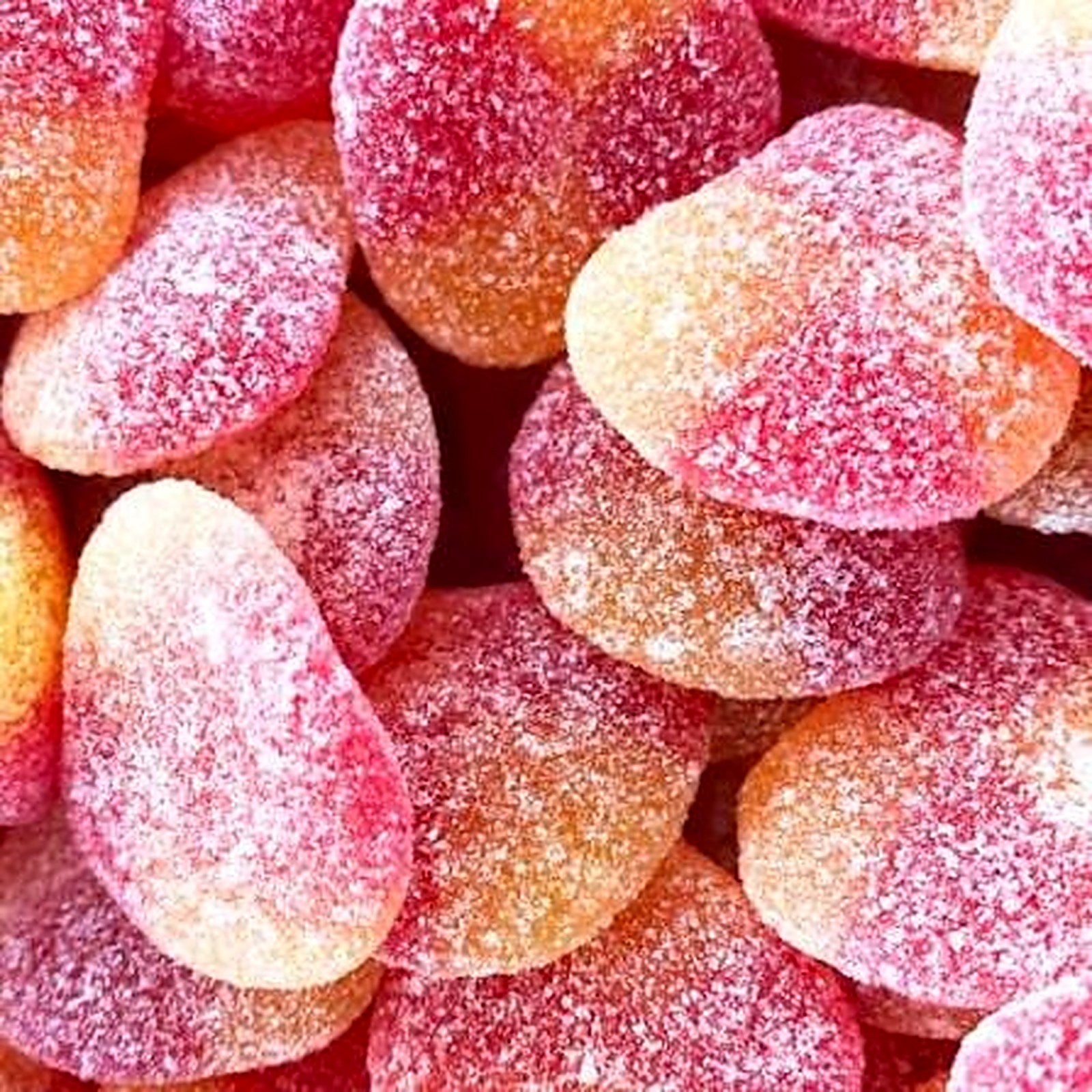 Gesuikerde perziken in roze en oranje met suikerlaag